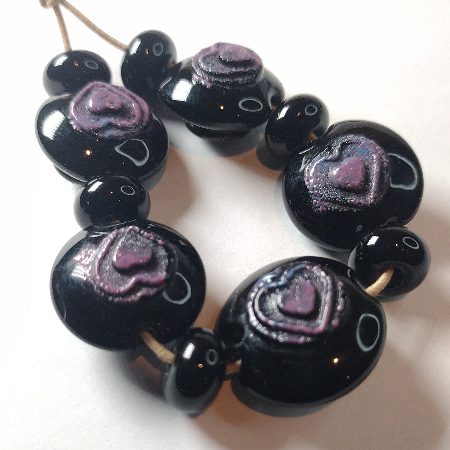 Black lentils with purple textured hearts lampwork bead set Jolene Beads